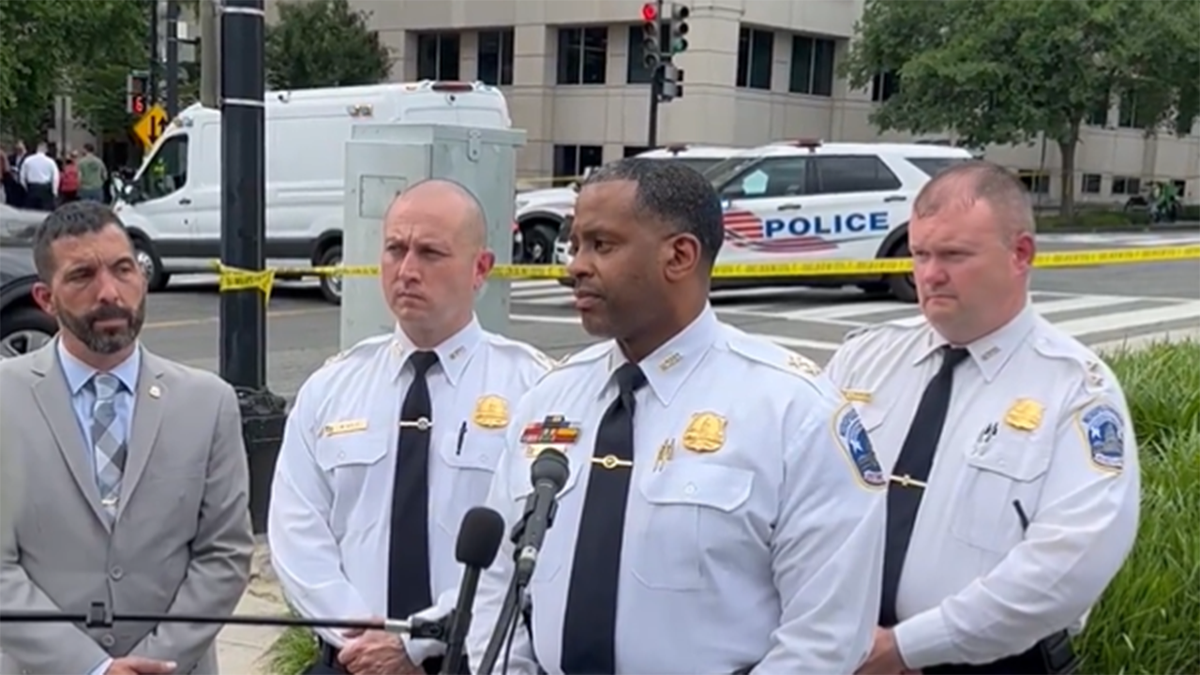 D.C. Assistant Police Chief Darnel Robinson and other police officials at crash site
