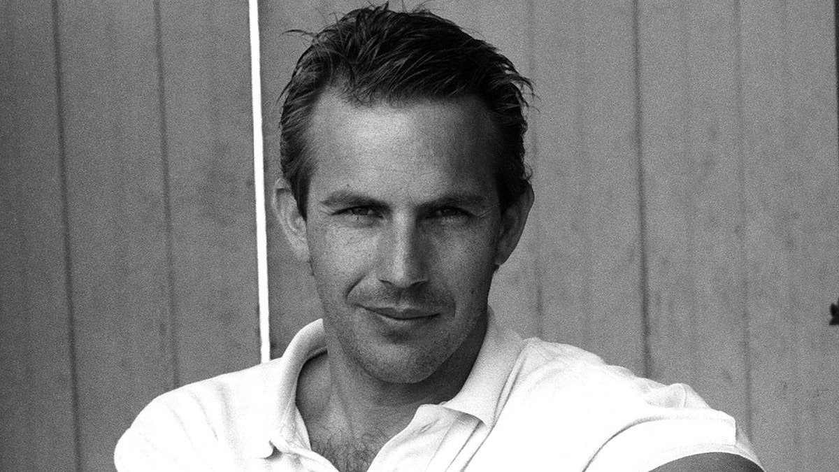 Kevin Costner in a black and white photo taken in 1985.