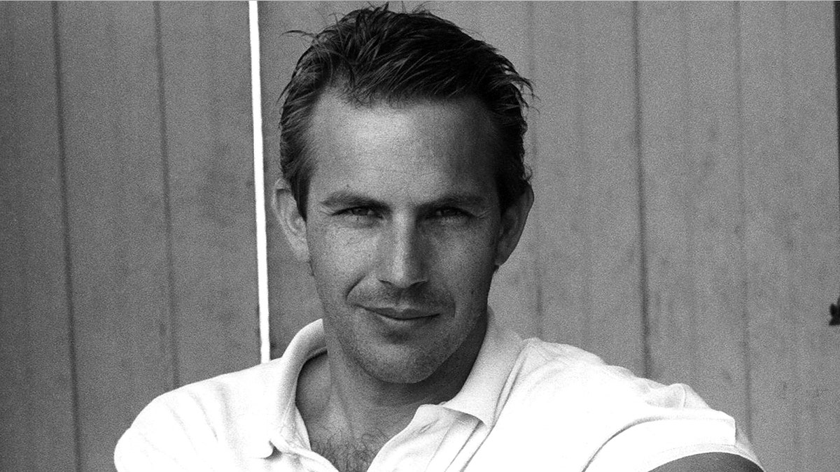Kevin Costner in a black and white photo taken in 1985.
