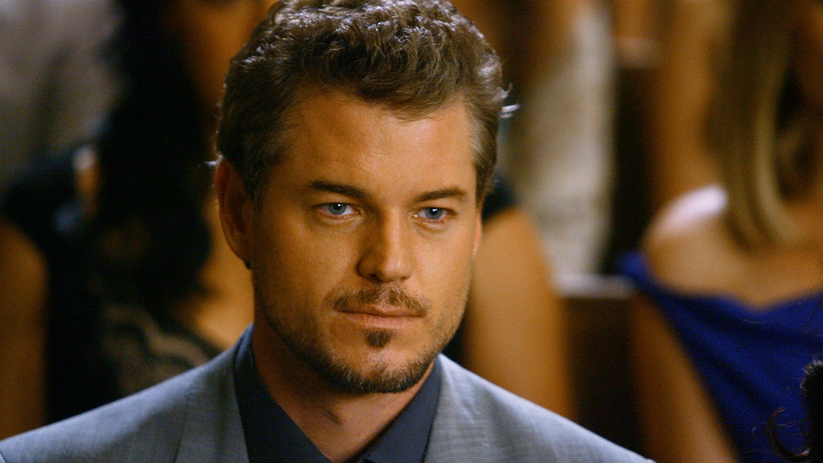 Eric Dane looking serious as Dr. Mark Sloan in a blue suit in "Grey's Anatomy"