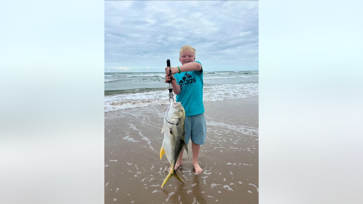 Hub Haltermann, age 10, displays the bait that caught a massive hammerhead shark in Texas.
