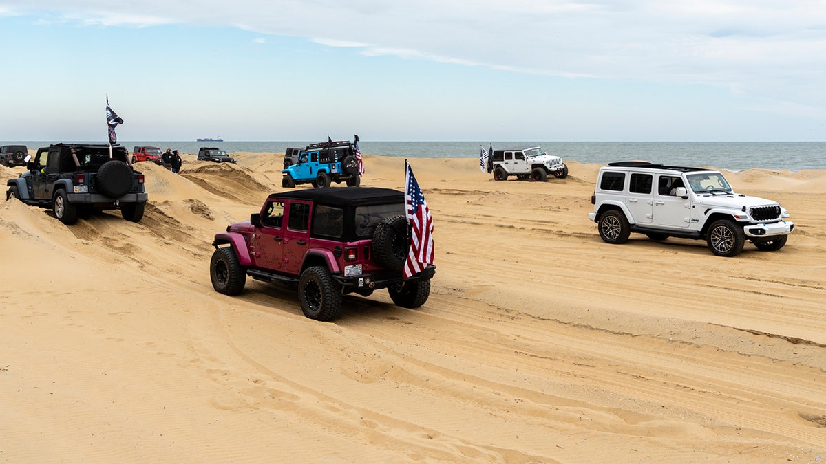 Jeeps driving in the sand
