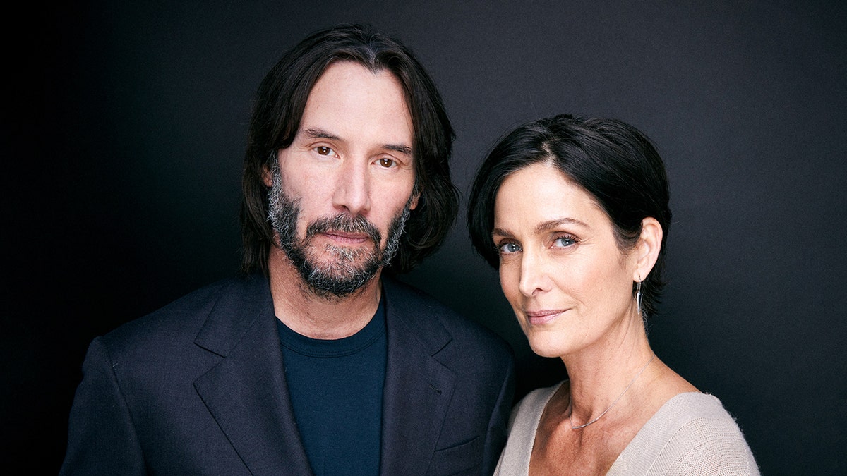 The Matrix stars Keanu Reeves and Carrie-Ann Moss pose for portrait sessions.