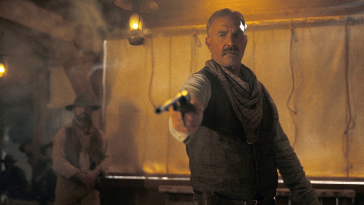 Actor Kevin Costner shoots a gun in Western drama
