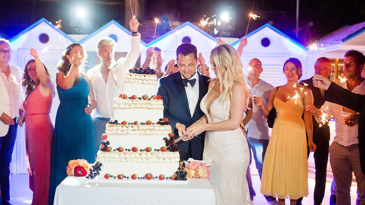 Couple cutting wedding cake