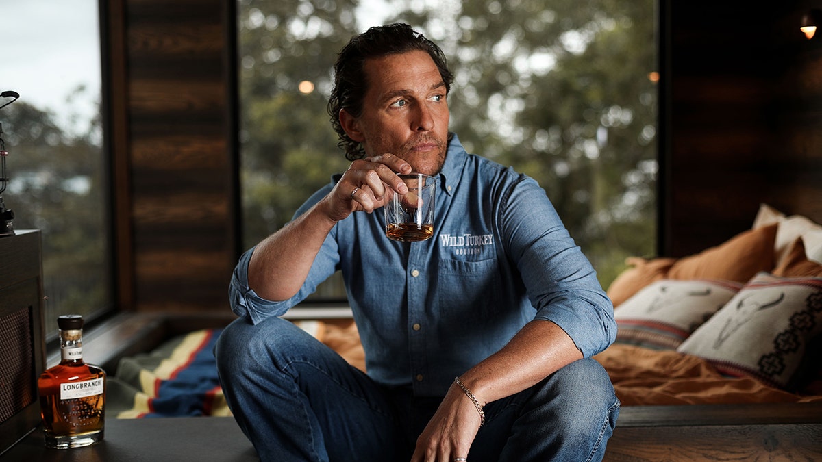 Matthew McConaughey sitting in a cabin