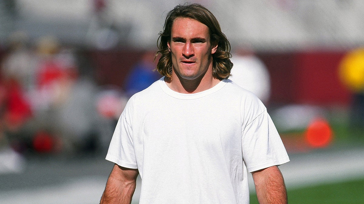 Pat Tillman in a white t-shirt walks before an Arizona Cardinals game