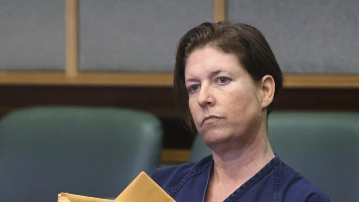 Defendant Sarah Boone holds envelopes during a pre-trial hearing in Orlando, Fla., Friday,