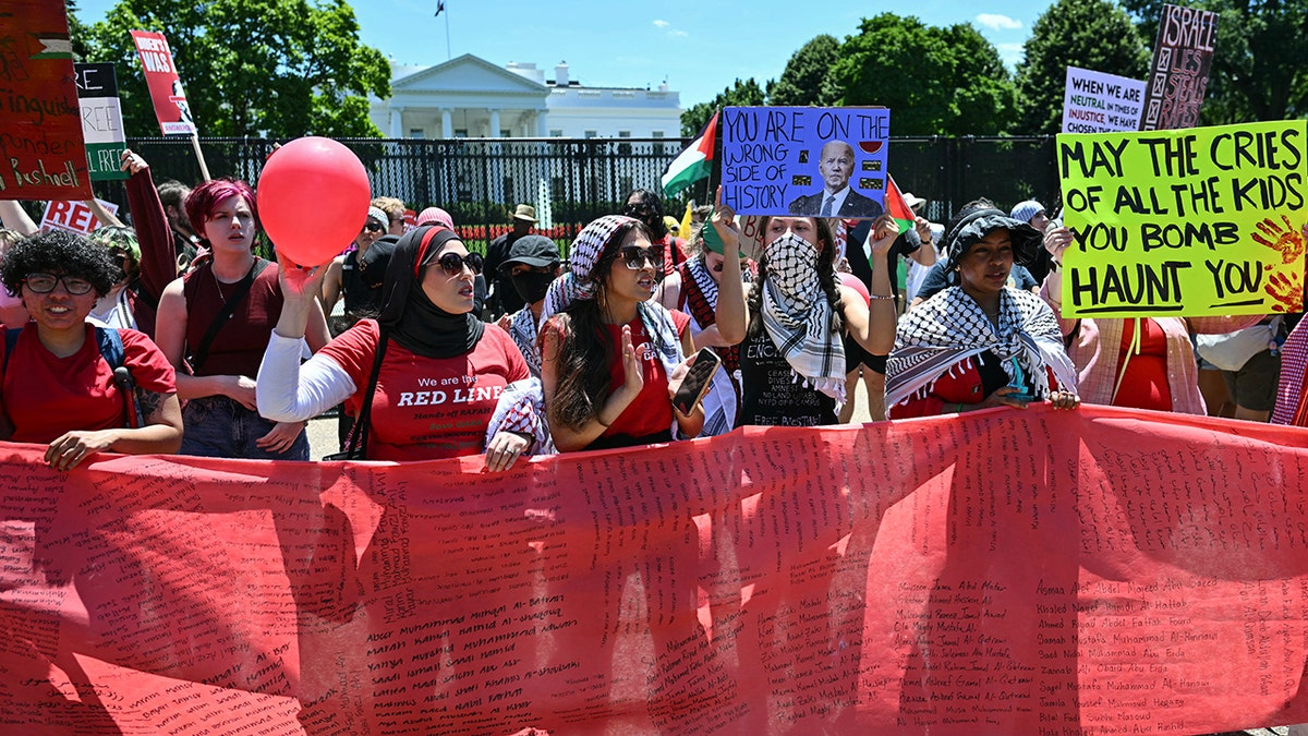 Anti-Israel demonstrators, in formation holding a "red line," rally near the White House on Saturday.