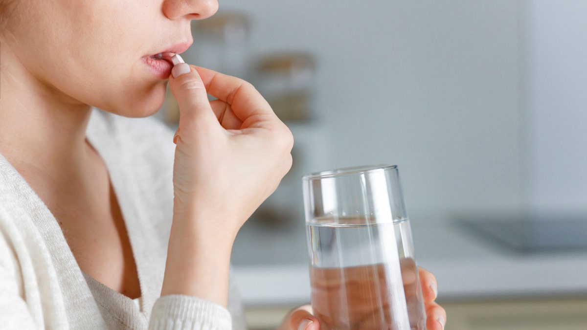 Woman taking pill