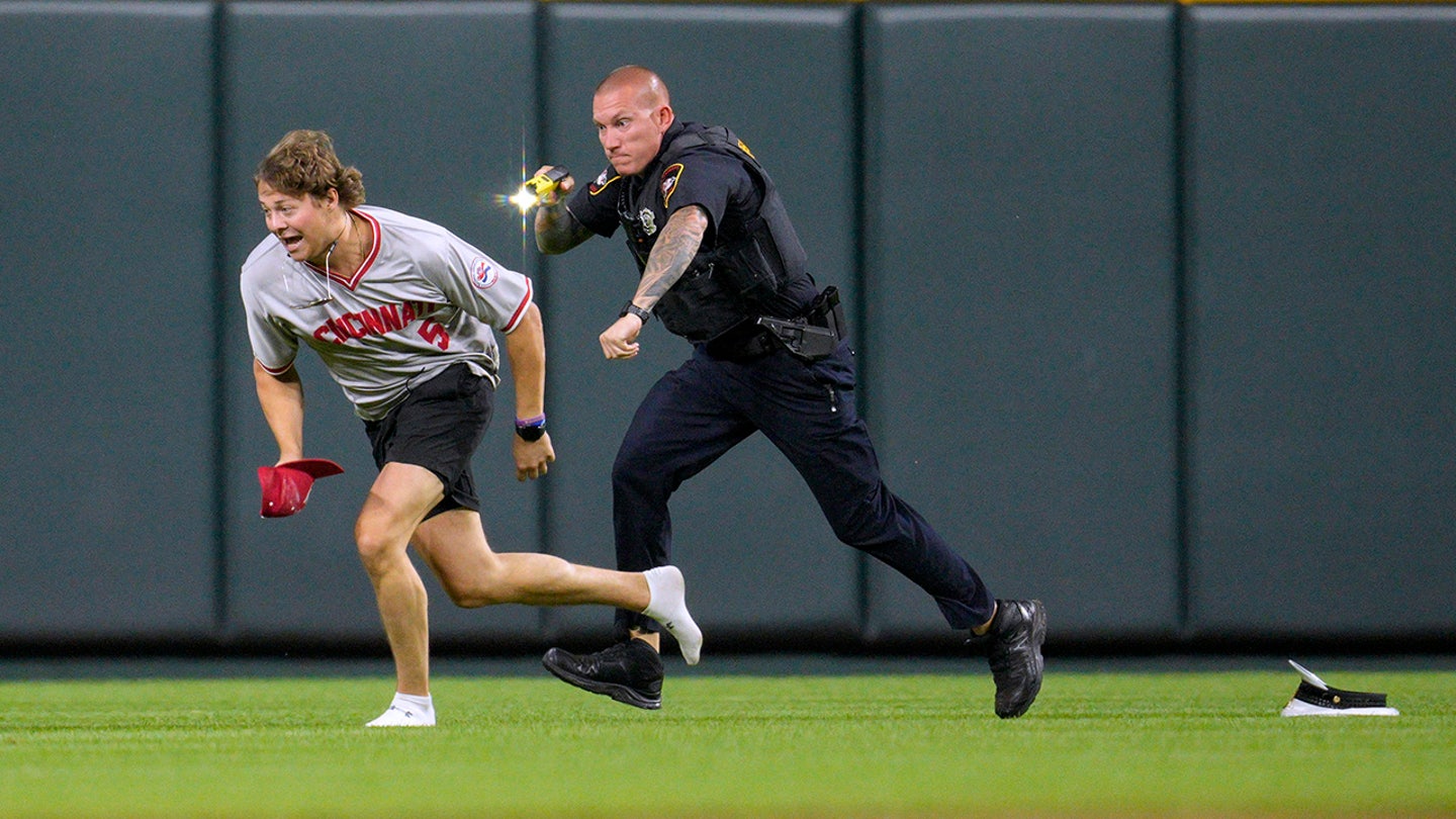 Reckless Thrill-Seeker: Reds Fan Tasered After Daring Field Invasion and Backflip