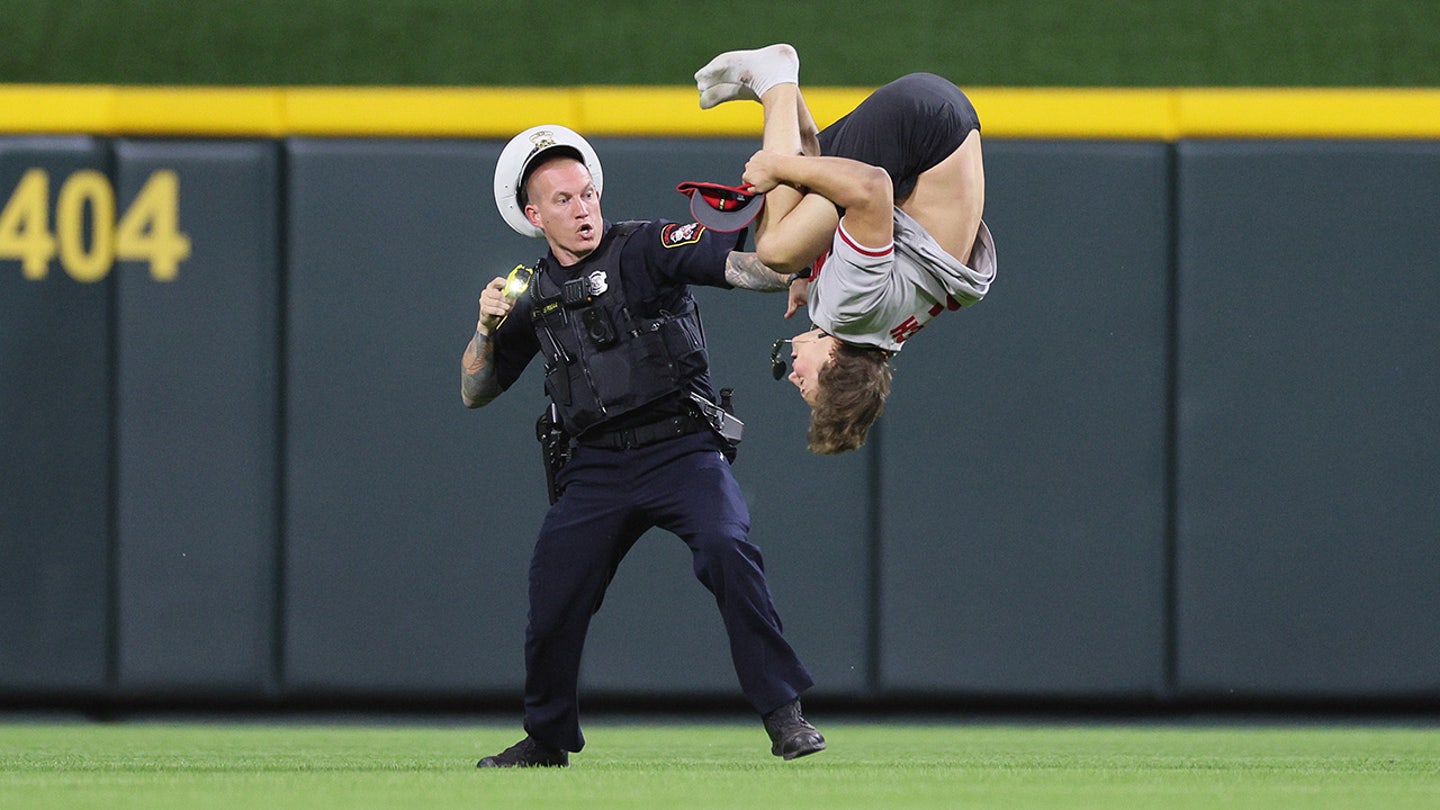 Reckless Thrill-Seeker: Reds Fan Tasered After Daring Field Invasion and Backflip