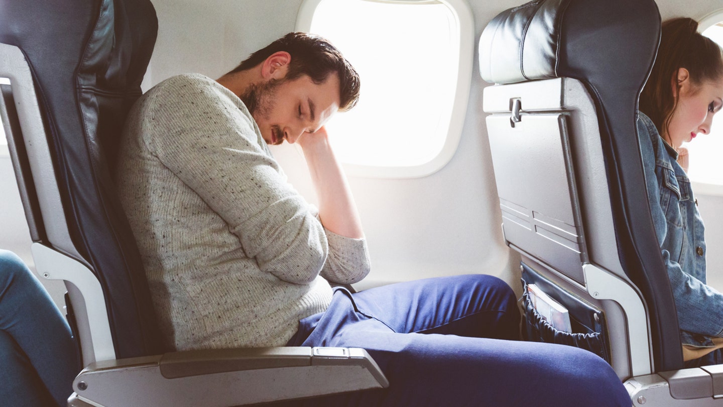 man sleeping plane