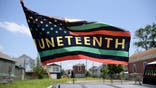 A Juneteenth flag flies on a float during the 45th annual Juneteenth National Independence Day celebrations in Galveston, Texas, on June 15, 2024. Juneteenth falls on June 19 and has often been celebrated on the third Saturday in June, to mark the end of slavery in the US. (Photo by Mark Felix / AFP) (Photo by MARK FELIX/AFP via Getty Images)