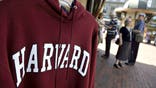 UNITED STATES - SEPTEMBER 03:  A Harvard University logo appears on a sweatshirt on display in Harvard Square in Cambridge, Massachusetts, U.S., on Friday, Sept. 4, 2009. Community activists in Allston, a section of Boston across the Charles River from Harvards main campus in Cambridge, say university delays have left a  (Photo by Michael Fein/Bloomberg via Getty Images)