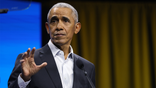 obama holds hand up