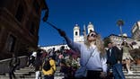Girl on trip in Italy taking a selfie with a selfie stick