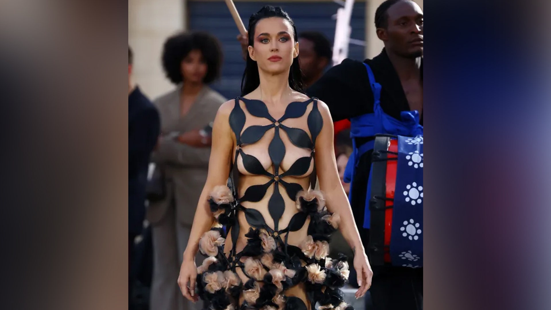 Katy Perry showed off her toned body in a black "naked" dress, with cutouts all throughout, when she walked the runway during Vogue World: Paris.