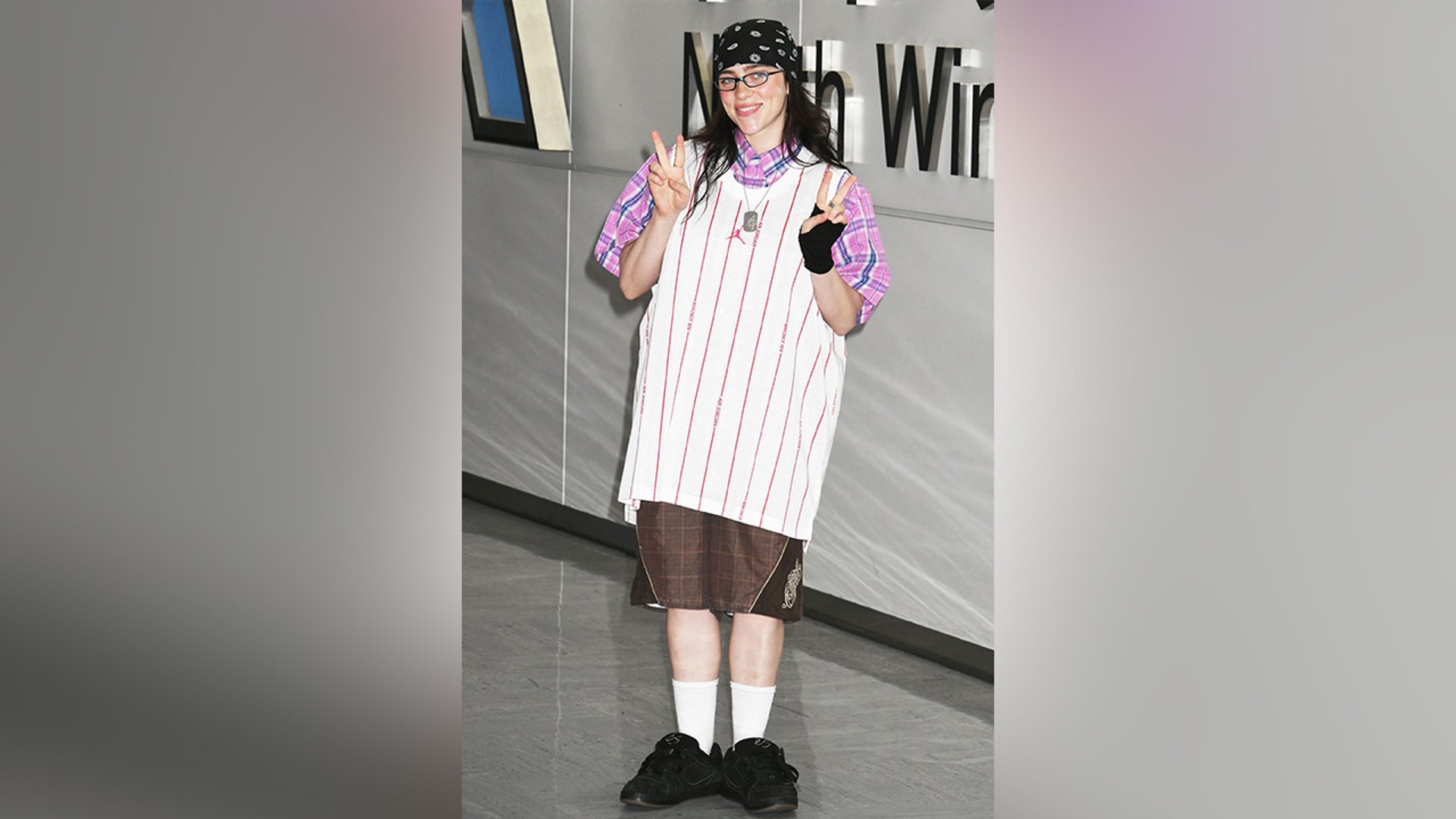 Billie Eilish posed for photos after landing in Tokyo, Japan for her concert.