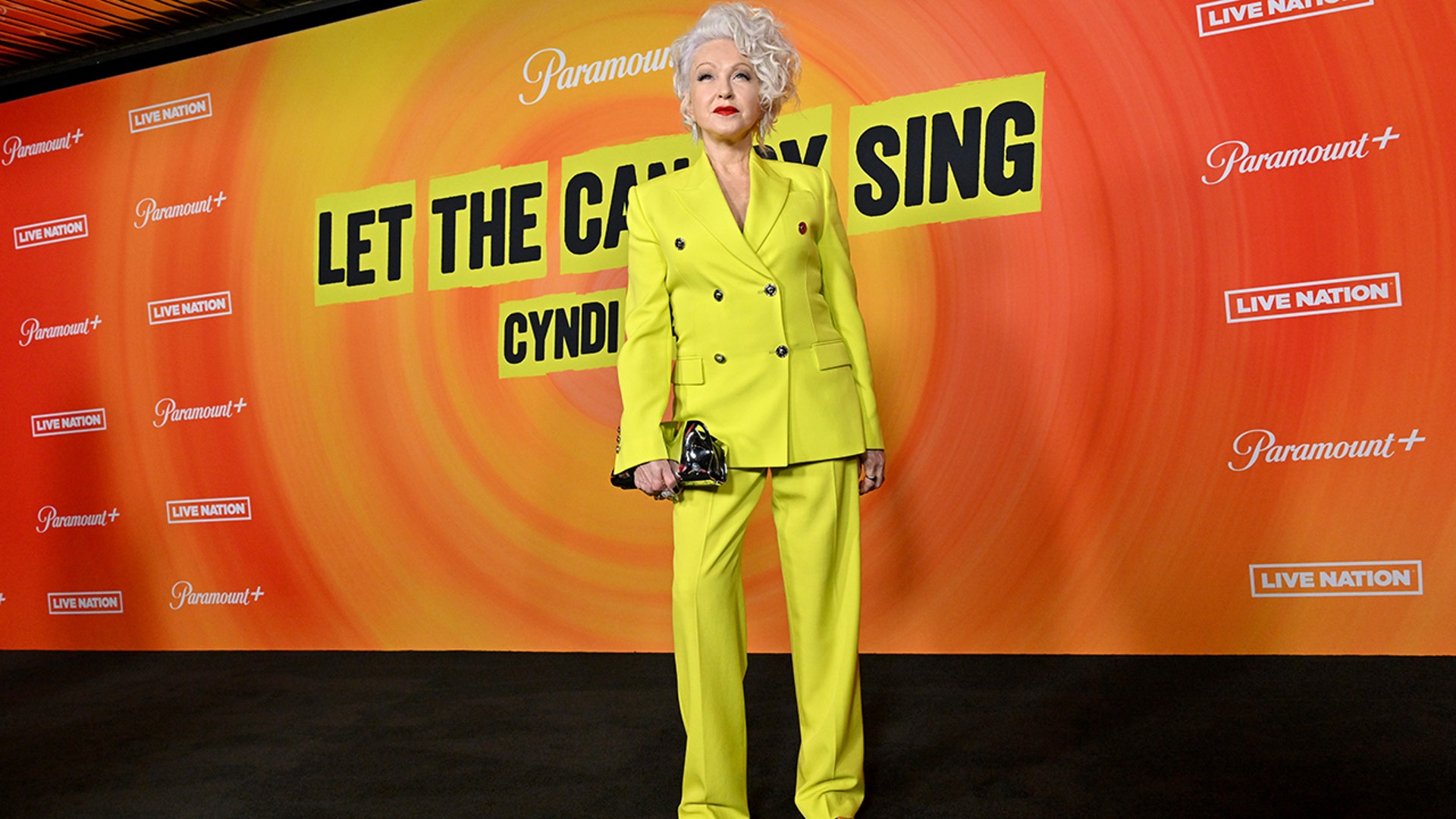 Cyndi Lauper walked the red carpet at the premiere of her documentary "Let The Canary Sing," in a matching double-breasted yellow blazer and trousers.