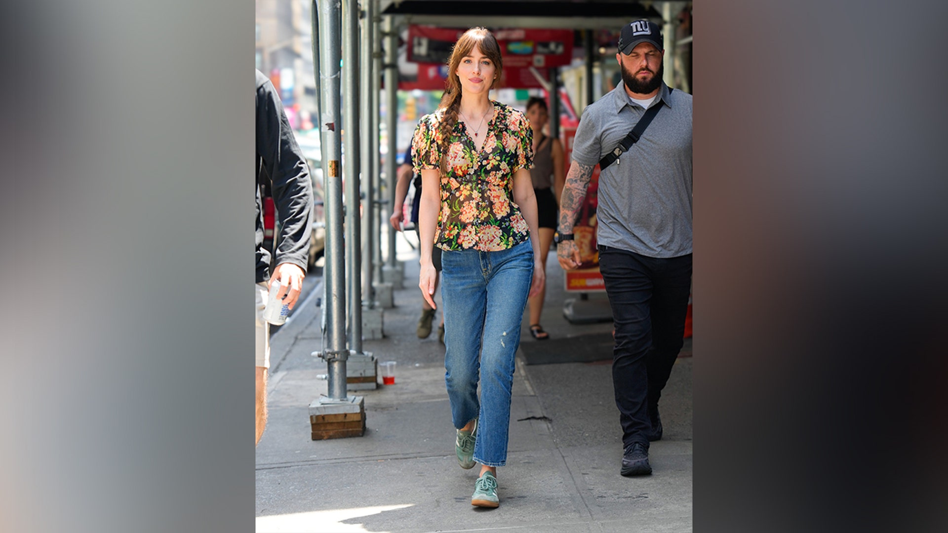 Dakota Johnson kept it casual while on location for her latest project "Materialists," in a semi-sheer floral shirt and jeans.