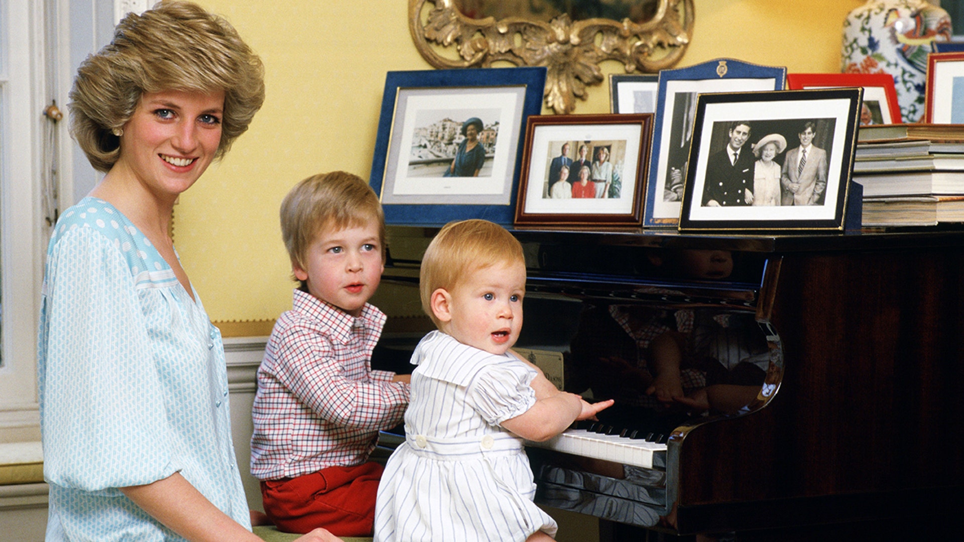 Princess Diana sits with her two boys in front of the piano in their Kensington Palace home.