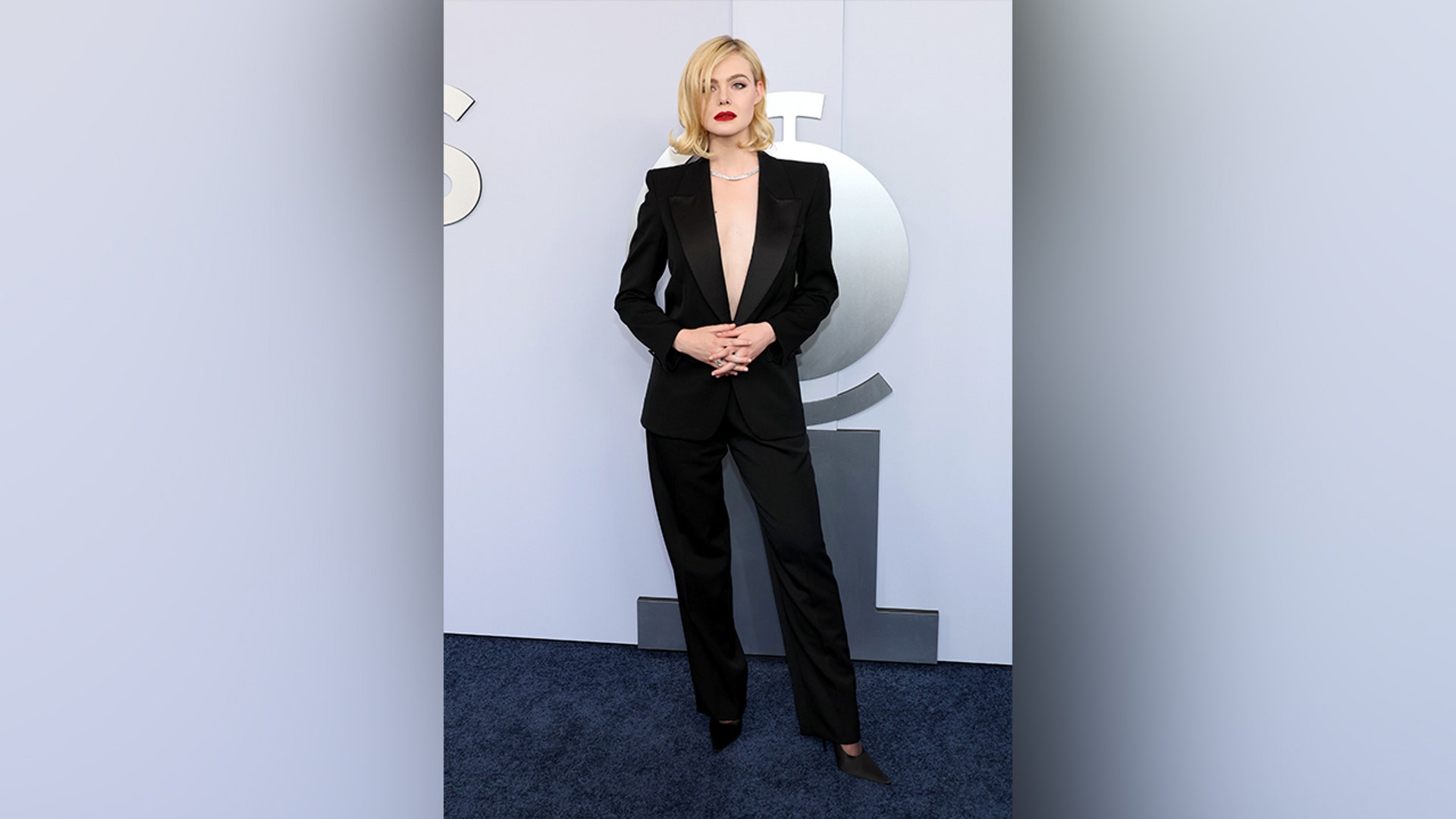 Elle Fanning wore a black suit with a plunging neckline when walking the red carpet at the 2024 Tony Awards.