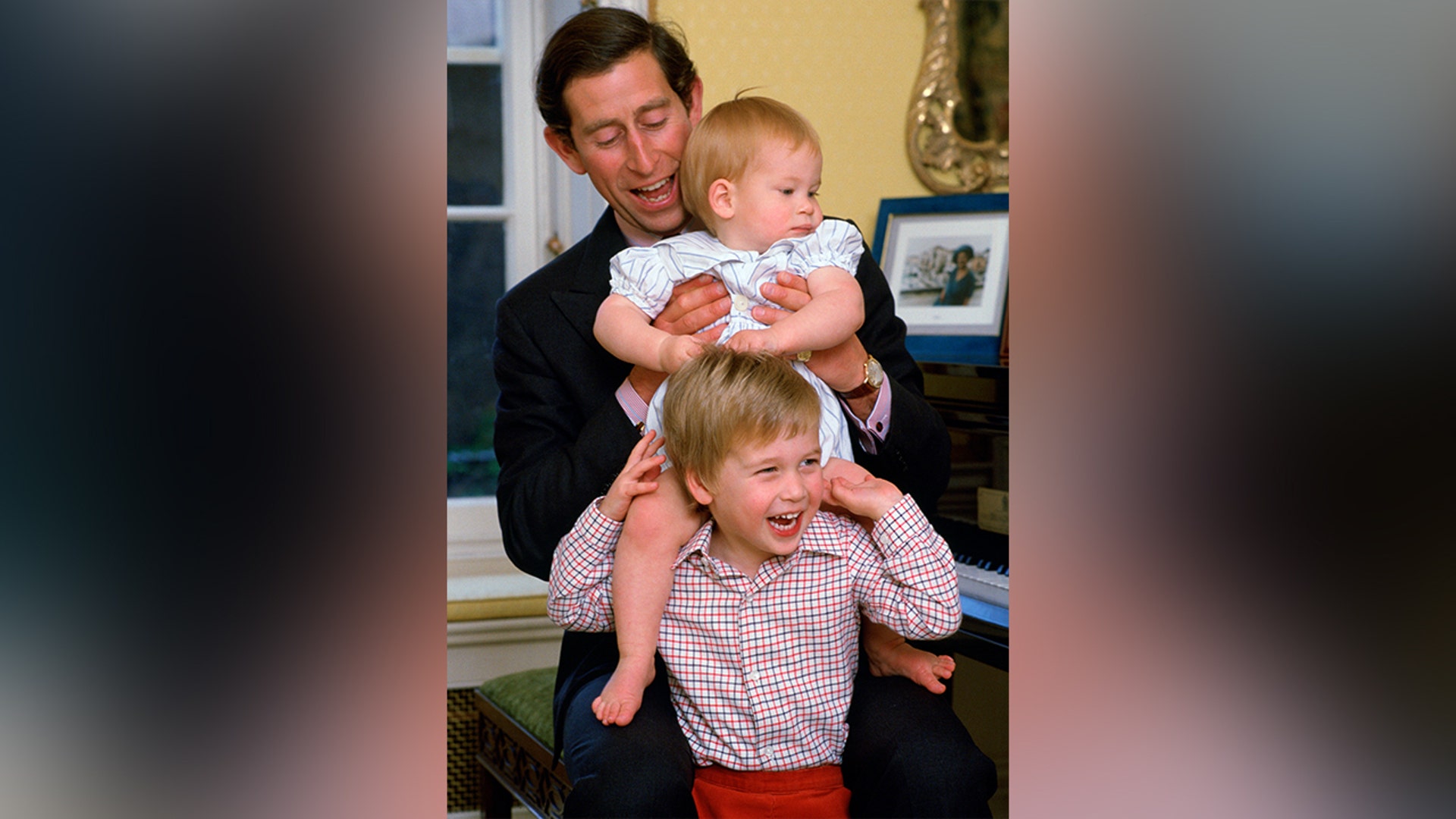 Prince William had some fun with his brother and dad during a photoshoot in October 1985.