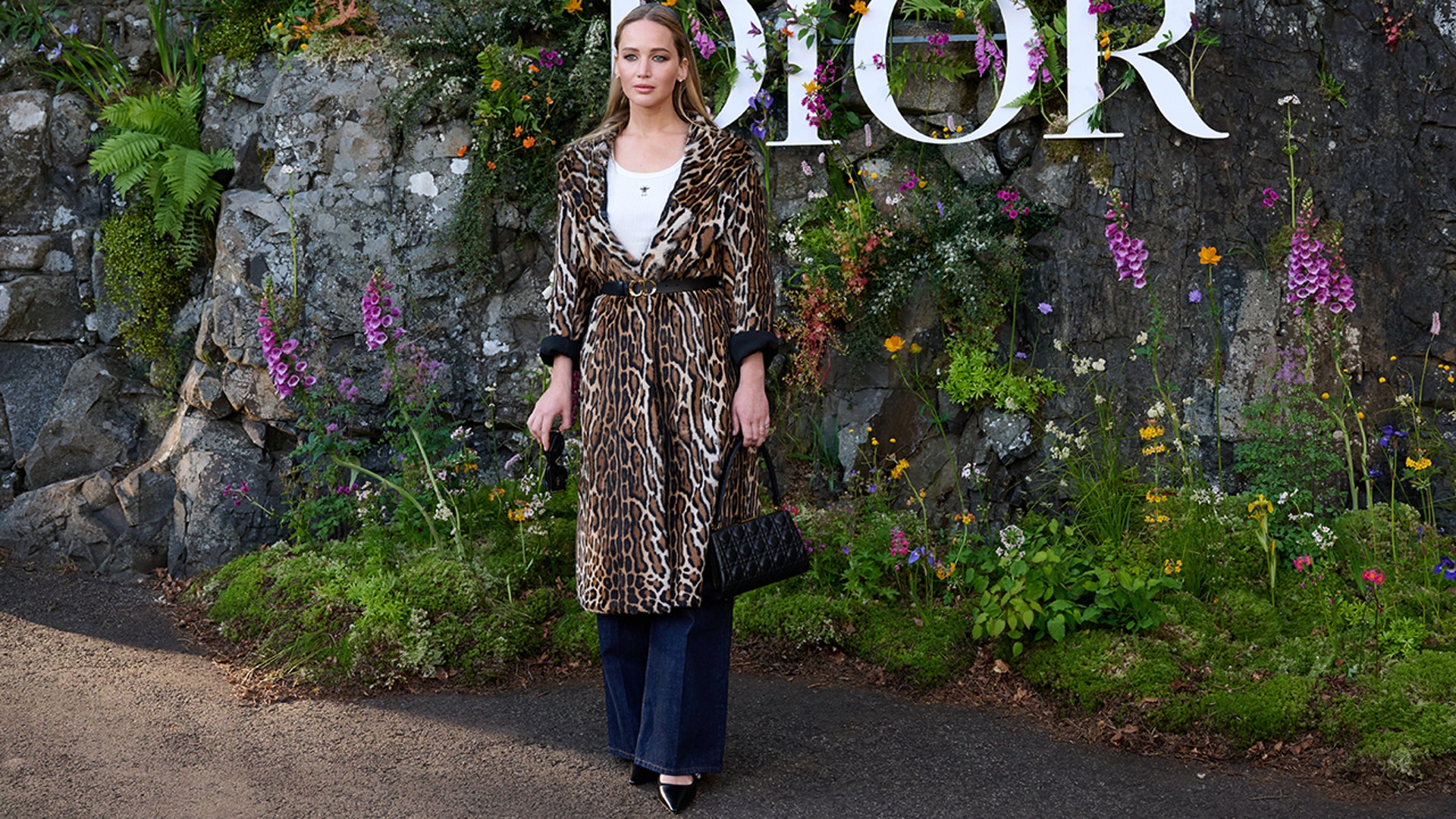 Jennifer Lawrence stunned in wide legged jeans, a white top and a leopard print coat.