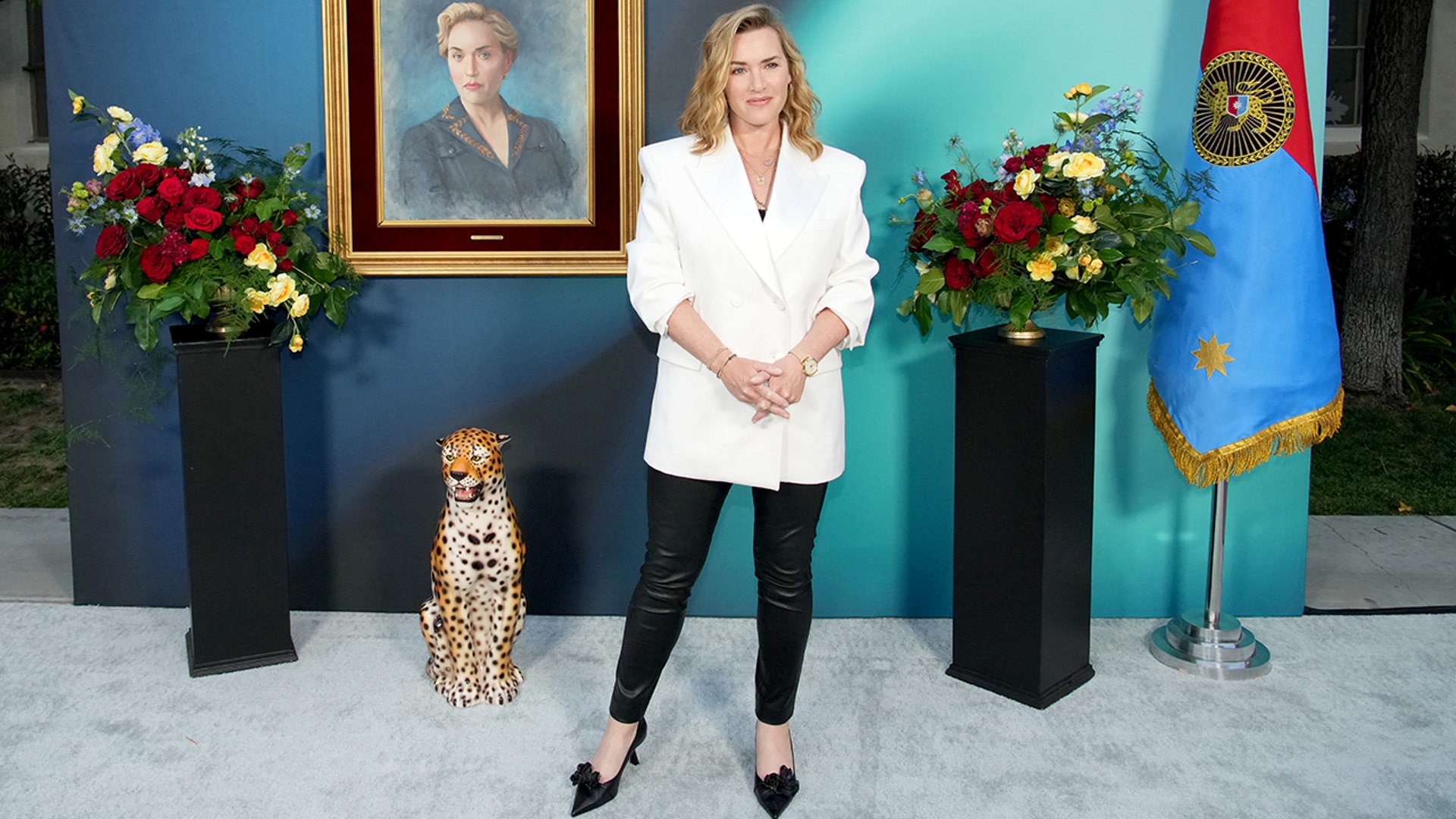 Kate Winslet wore a white suit jacket with black pants when walking the carpet at "The Regime" FYC panel event.