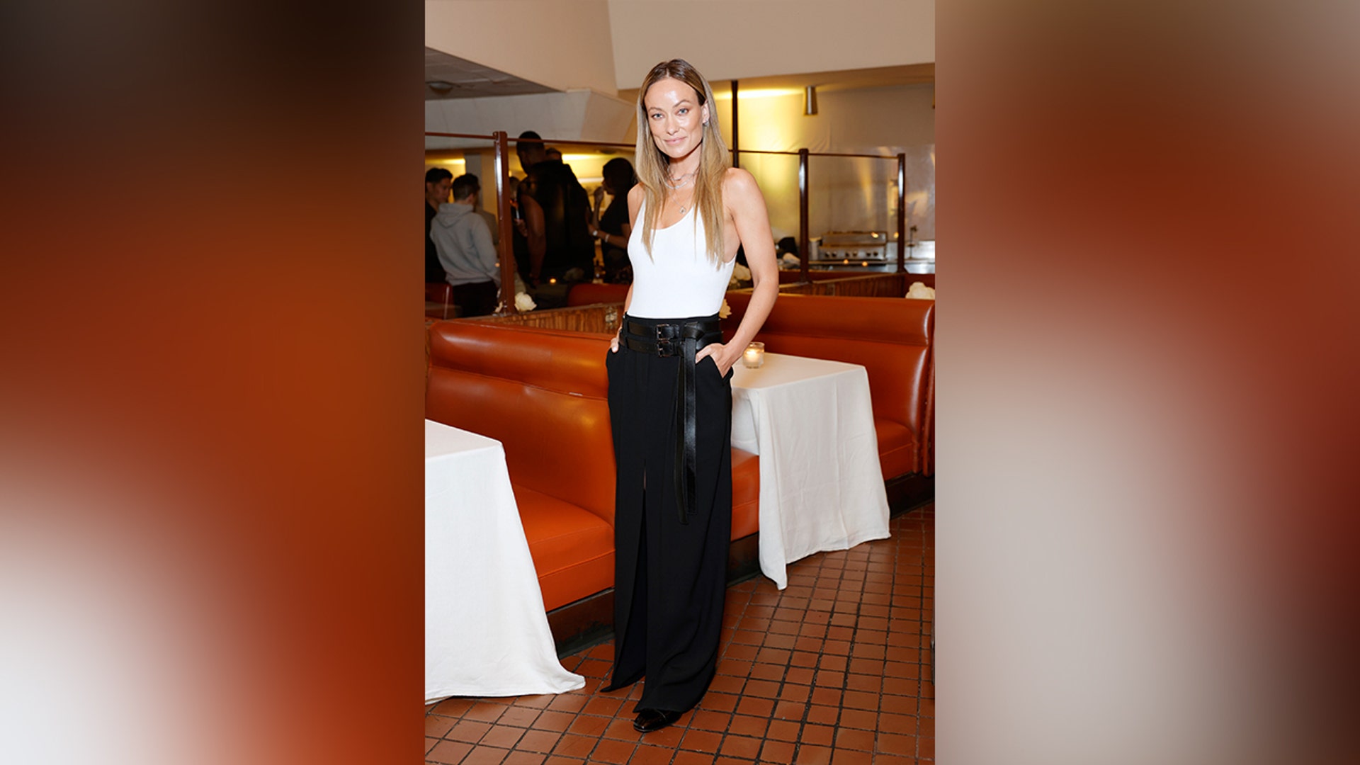 Olivia Wilde attended Michael Kors' new store, in an American Label white tank top and black trousers.