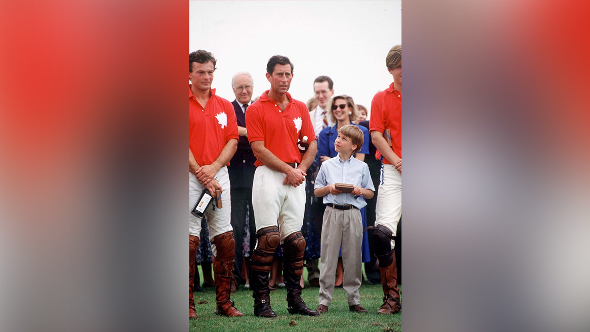 Prince William looking up to his father while at a polo match in 1990.