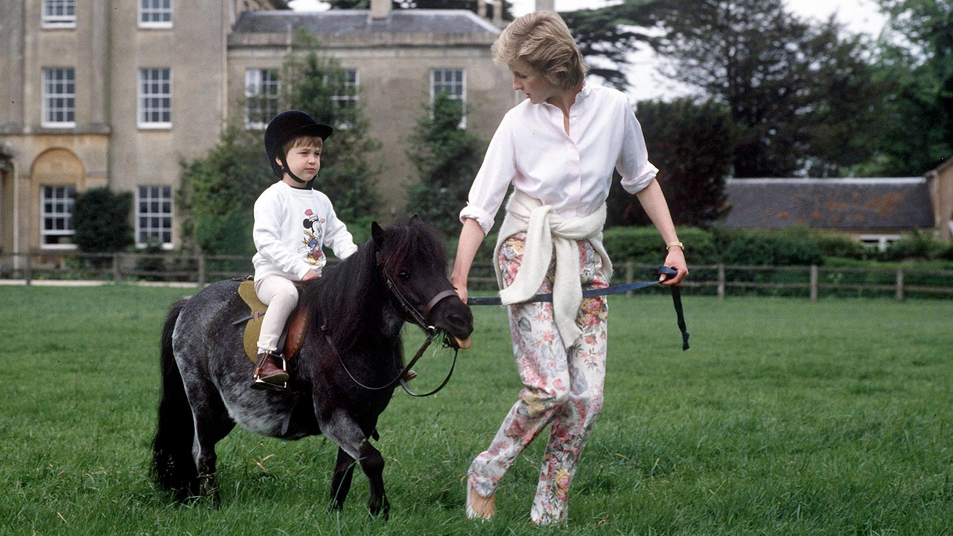 Prince William and Princess Diana going for a ride on a pony at Highgrove.