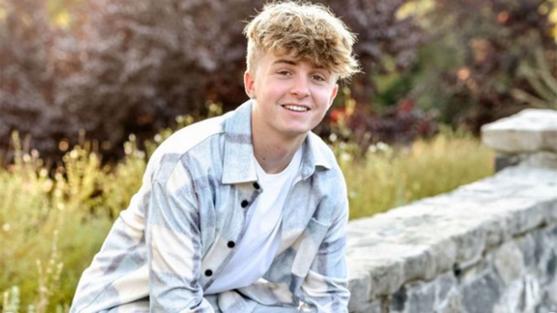 Ryder Fieri sitting in front of a field of grass