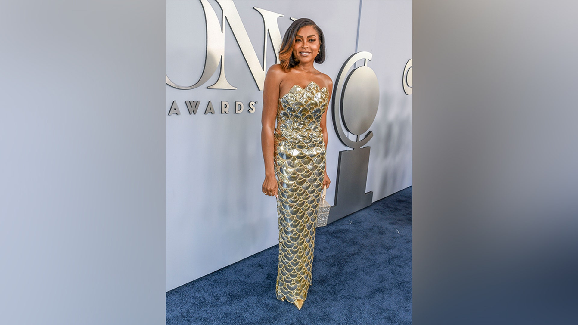 Taraji P. Henson stunned in a strapless metallic gold dress, with scalloped designed all throughout, when walking the red carpet at the Tony Awards.