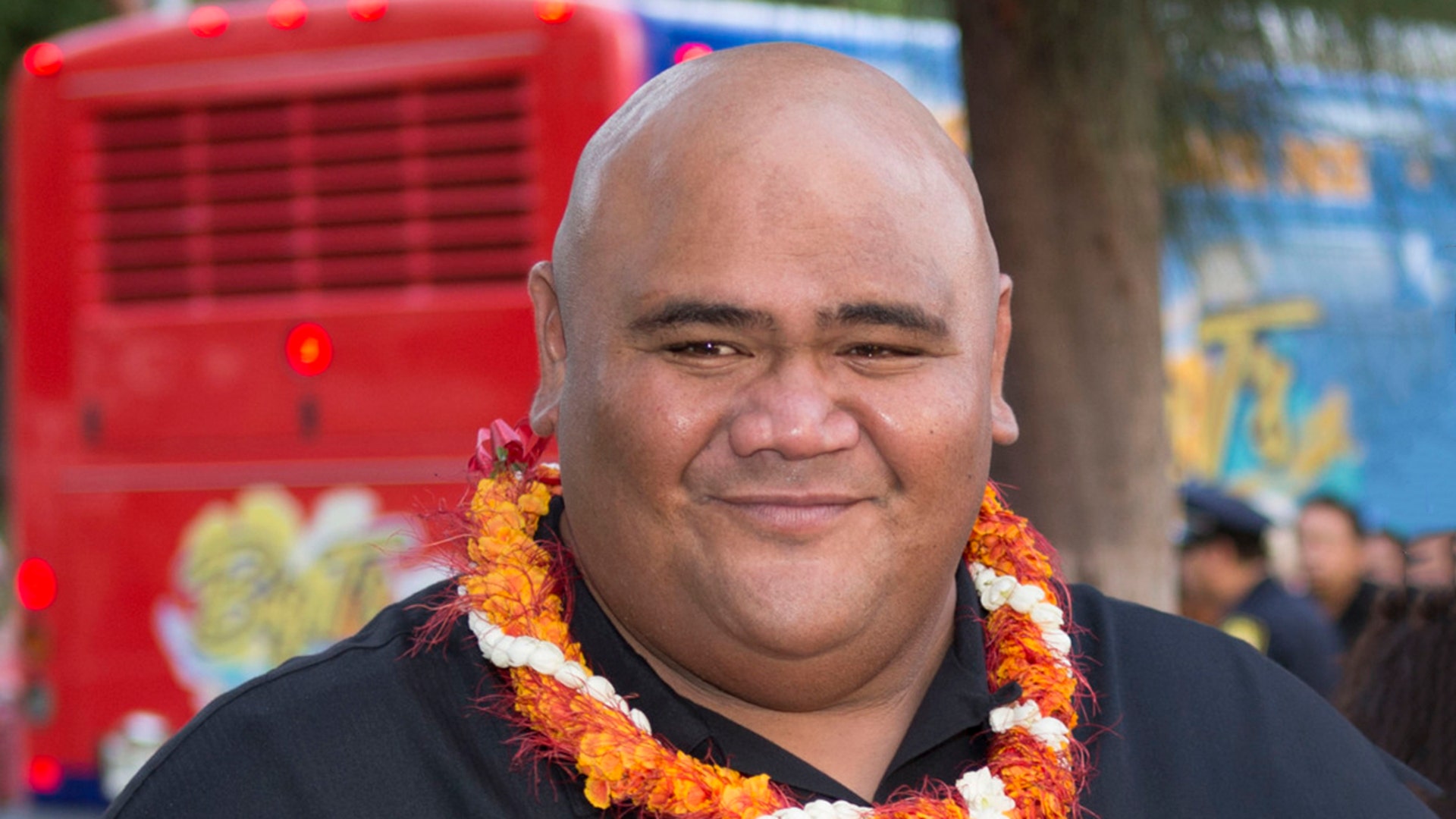 Actor Taylor Wily wears an orange lei at Hawaii Five-0 premiere.