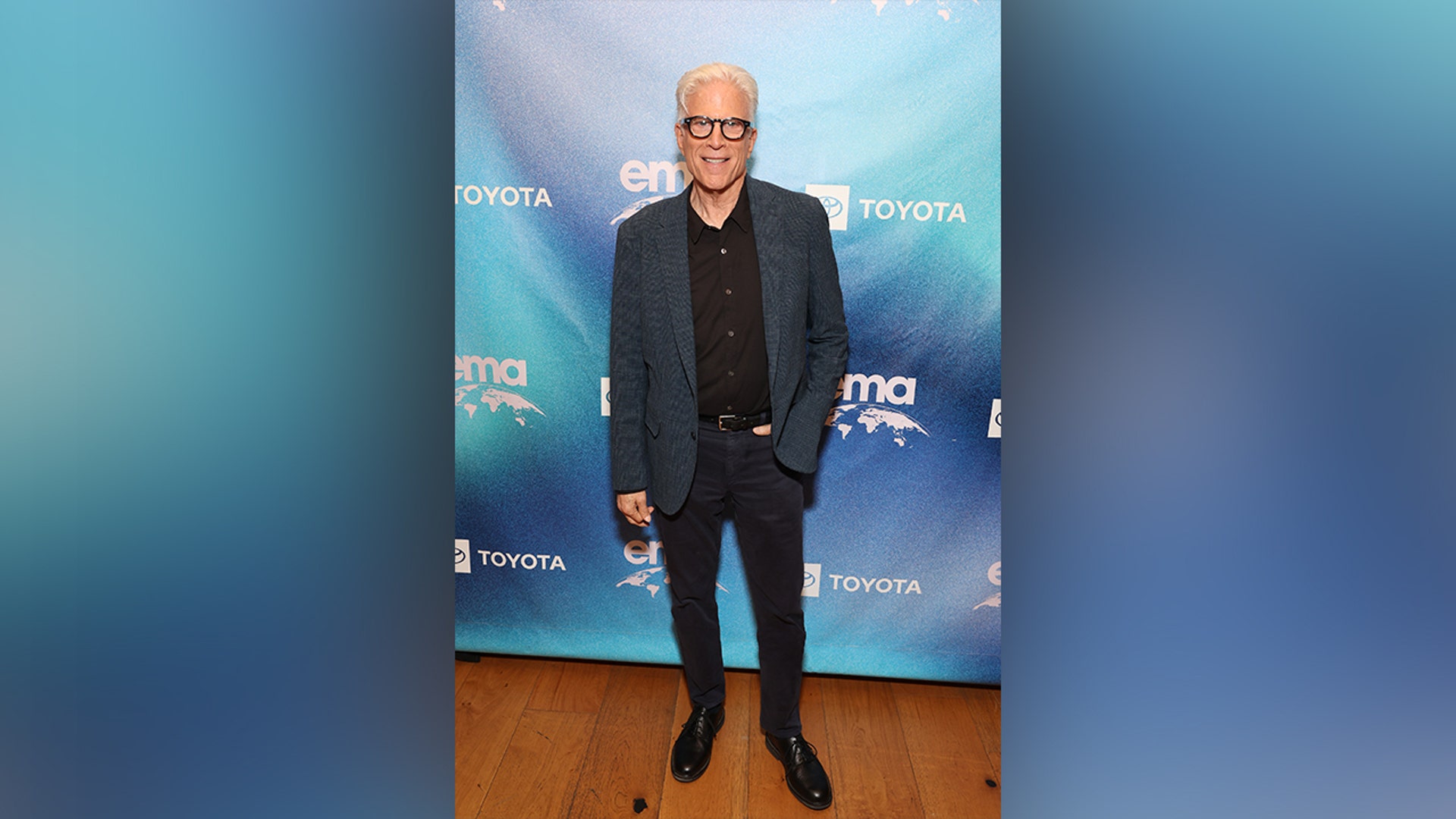 Ted Danson attended the the Environmental Media Association IMPACT Summit in a black shirt with a blue jacket.