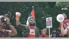 Anti-Israel agitator in Hamas headband holds up bloodied Biden face mask steps from White House