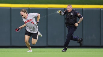 Moment MLB fan tased after running onto field and doing backflip in front of officer