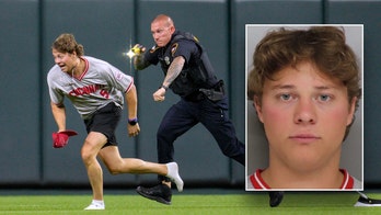 Reds fan tased and arrested after running onto field and doing backflip in front of officer