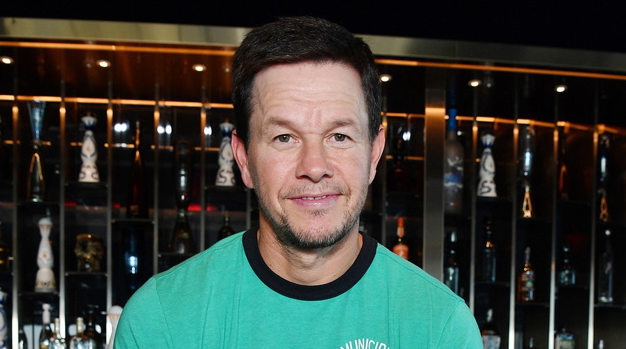 Mark Wahlberg prays with bishop at the opening of his new restaurant