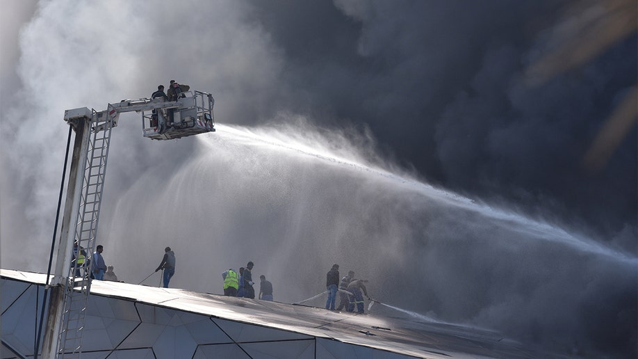 Firefighters dousing a building fire in Kuwait.