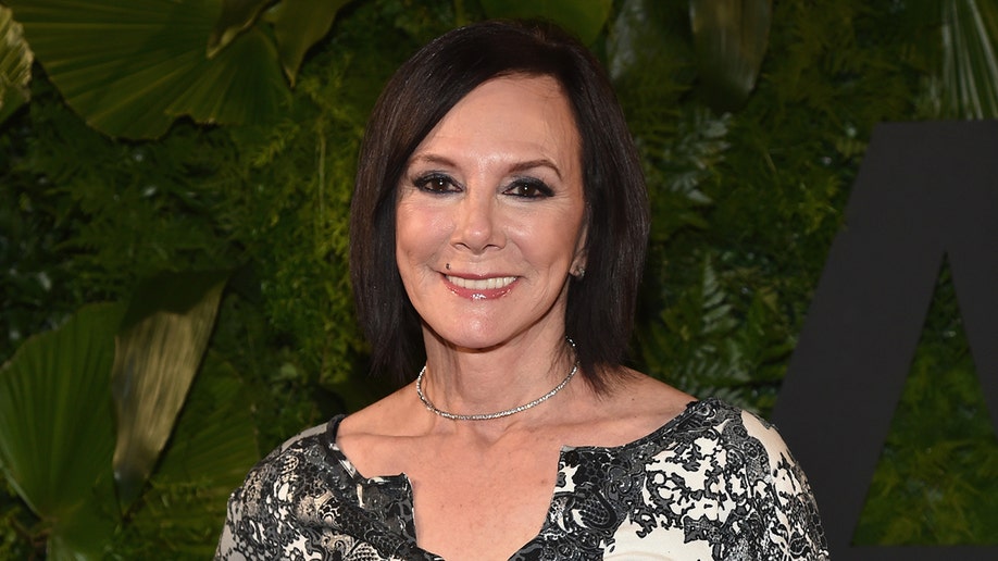 Marcia Clark wears black and white floral blouse.