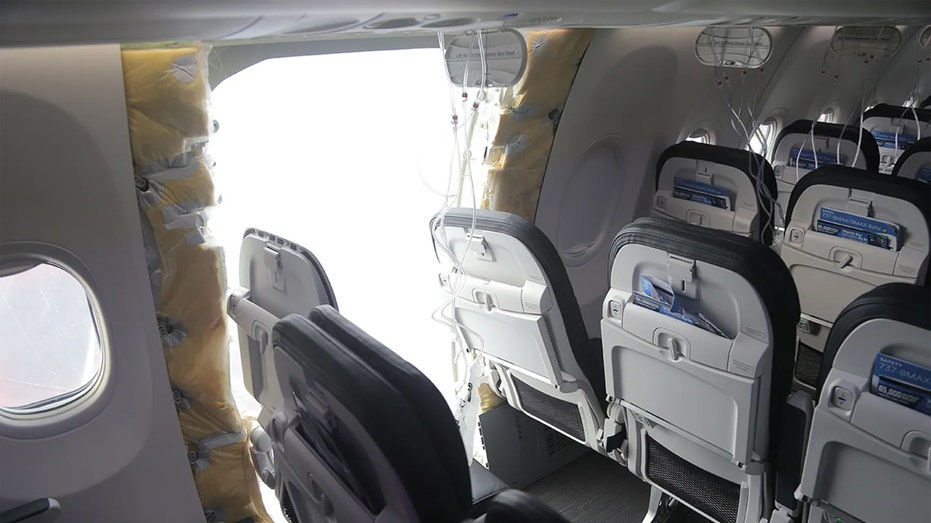 Boeing Jet with large holes in the walls and missing door panels