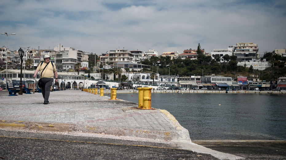 Body found near Greek beach with 22-pound barbell attached to leg, coast guard says