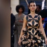 Katy Perry showed off her toned body in a black "naked" dress, with cutouts all throughout, when she walked the runway during Vogue World: Paris.