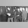 Walter Cronkite, Frank Starr, Melvin K. Whiteleather, Robert Wilson and Alex Paton dash for the phone to transmit their news in Bloomsbury, England