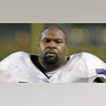 Larry Allen looks on