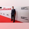 Austin Butler wore a navy blue suit with white pin stripes when posing for photos at "The Bikeriders" premiere in Sydney, Australia.