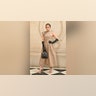 Jennifer Lopez in a pleated beige dress while on the red carpet at the Christian Dior fashion show.